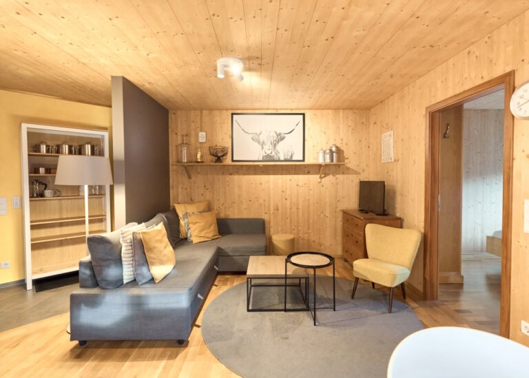 Gemütliches und modernes Wohnzimmer mit viel Holz in der Ferienwohnung Almrausch.